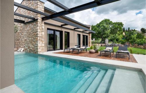 a swimming pool with chairs and a house at Villa Silente in Bale