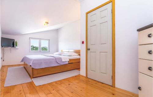 a bedroom with a bed and a door at Three-Bedroom Apartment In Rogotin in Rogotin