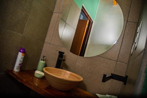 a bathroom with a wooden sink and a mirror at Cabañas 2Tierras in Chicoana