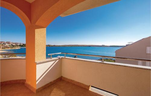 a balcony with a view of the water at Beautiful Apartment In Povljana in Povljana