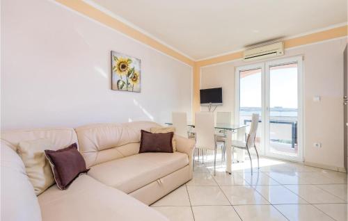 a living room with a white couch and a table at Beautiful Apartment In Povljana in Povljana