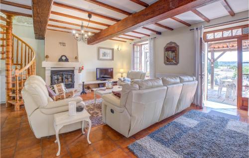 a living room with white furniture and a fireplace at 4 Bedroom Lovely Home In Douzillac in Douzillac