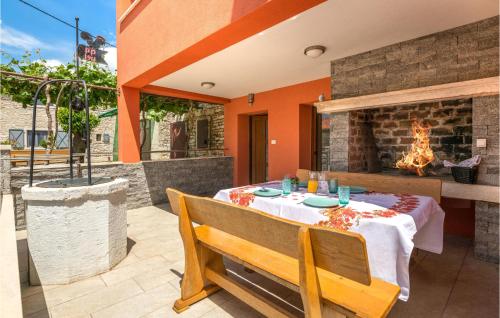 a dining room with a table and a fireplace at Beautiful Home In Krnica With Sauna in Krnica