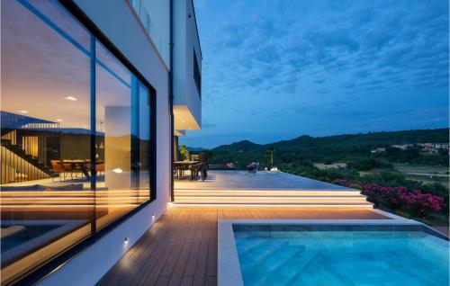 a house with a swimming pool on a balcony at Villa Carbon Residence in Labin