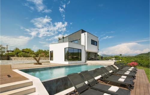 a villa with a swimming pool and lounge chairs at Villa Carbon Residence in Labin