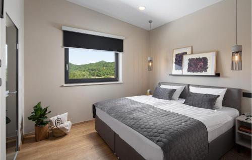 a bedroom with a large bed and a window at Villa Carbon Residence in Labin