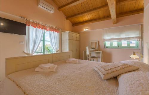 a bedroom with a large bed with two towels on it at Villa Judita in Tar
