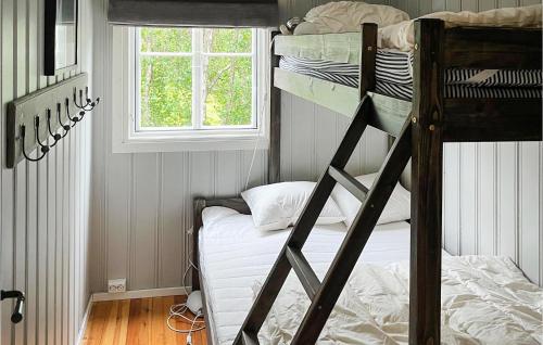 a bedroom with two bunk beds and a window at 3 Bedroom Nice Home In Gol in Gol