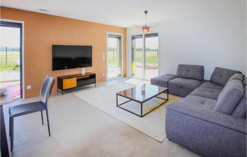 a living room with a couch and a tv at Lovely Home In Cléon D'andran in Cléon-dʼAndran
