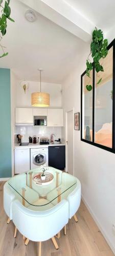 - une cuisine avec une table en verre dans une pièce dans l'établissement Arizona Dream - T1 Bis Climatisé 4p WiFi, à Toulouse