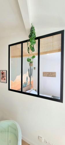 une fenêtre dans une pièce avec un cactus dans l'établissement Arizona Dream - T1 Bis Climatisé 4p WiFi, à Toulouse