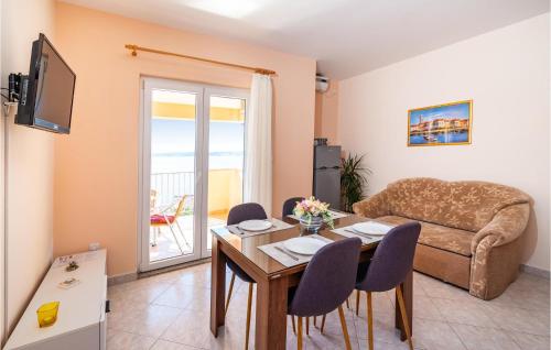 a living room with a table and a couch at Apartment Pavlinka Bb Iv in Posedarje