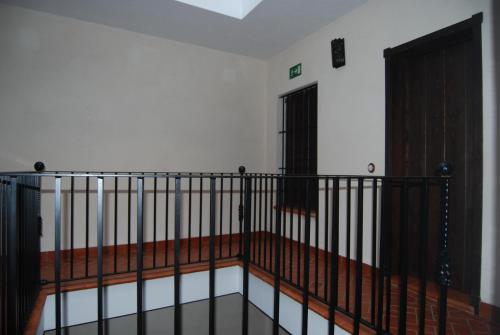 a room with a staircase with a gate and a door at Apartamentos Bodeguetas in Constantina