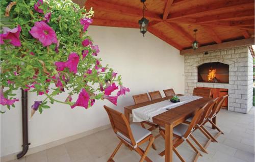 a dining room with a table and a fireplace at Apartment Sestanovac 23 With Outdoor Swimmingpool in Šestanovac