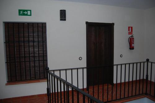 a room with a staircase and a fire hydrant on the wall at Apartamentos Bodeguetas in Constantina
