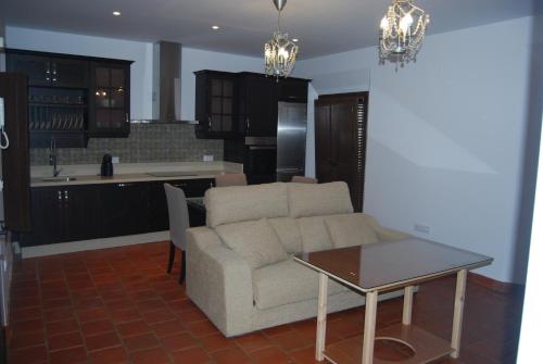 a living room with a couch and a table at Apartamentos Bodeguetas in Constantina