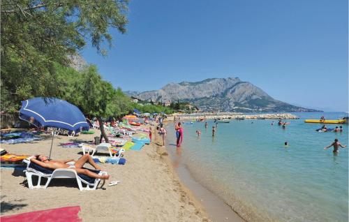 a beach with a lot of people in the water at Pet Friendly Home In Omis With Sauna in Omiš