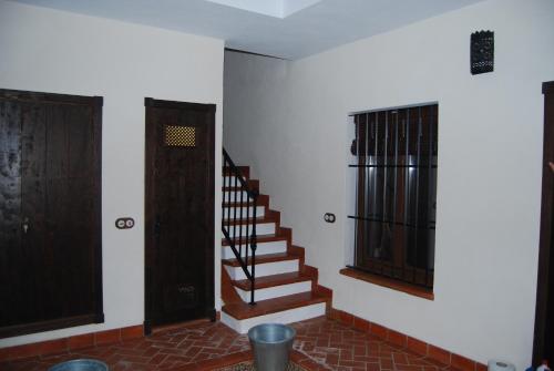 a room with a staircase and a window and a door at Apartamentos Bodeguetas in Constantina