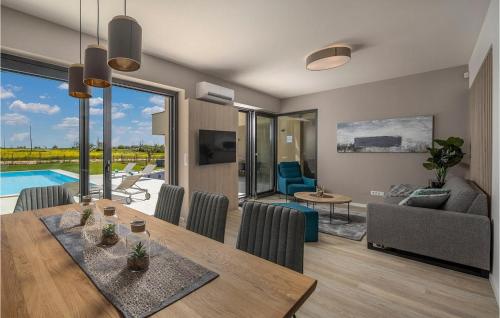 a living room with a table and a living room with a pool at Villa Estate in Brtonigla