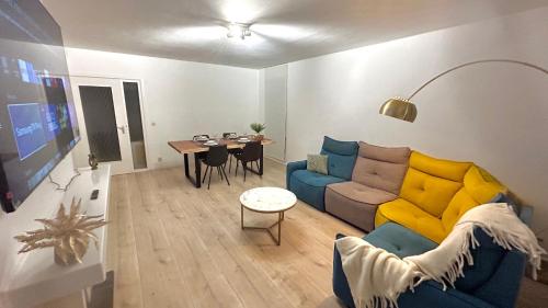 a living room with a couch and a table at Charming two bedroom flat - NATO - Brussels in Brussels