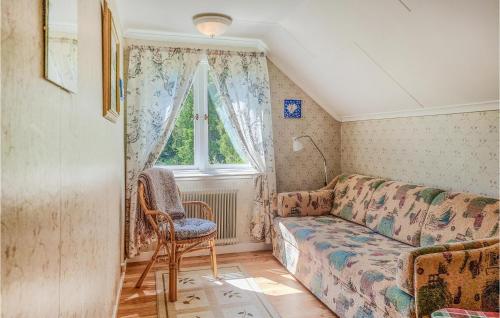 a living room with a couch and a window at Awesome Home In Fjällbacka With Wifi in Fjällbacka