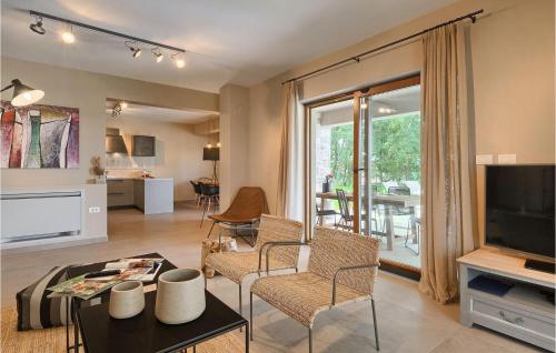 a living room with a couch and a tv and a table at Villa Brih Iii in Motovun