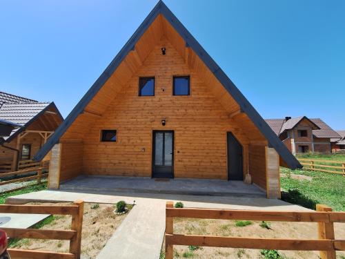 a large wooden house with a triangular roof at Planinska kuća Vesna in Sekulić 