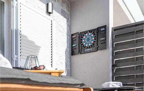 a dart board on a wall next to a window at Gorgeous Home In Srinjine in Srinjine