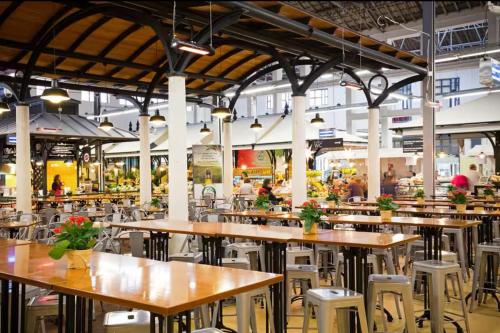 a cafeteria with tables and chairs in a building at Viver - Apartamento em Campo de Ourique in Lisbon