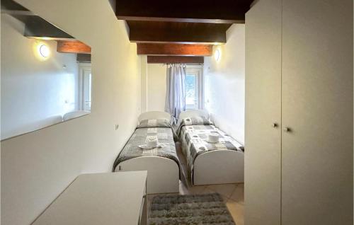 a row of beds in a room with a window at Gorgeous Apartment In Lecce Nei Marsi in Gioia dei Marsi