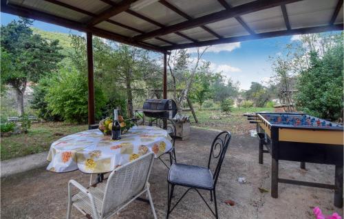 a patio with a table and a grill and a ping pong table at 3 Bedroom Nice Home In Campodimele in Campodimele
