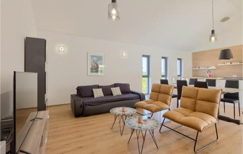 a living room with a couch and chairs and a kitchen at Villa Lia in Vintijan
