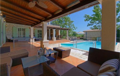 an outdoor patio with a pool and a house at Villa La Quercia in Poreč