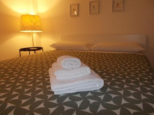 a bedroom with a bed with towels on it at Akihome Portanova in Naples