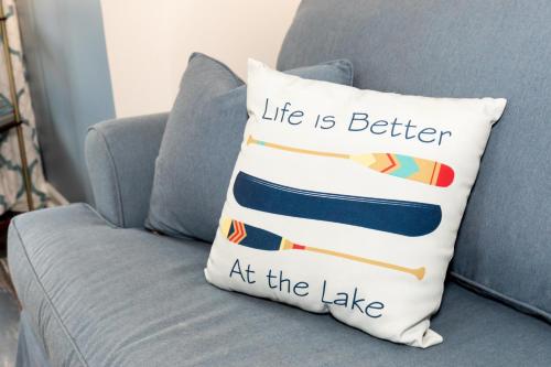 a pillow that says life is better at the lake at Explorers Cottage at Rye Beach in Huron