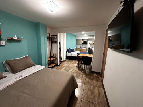 a bedroom with a bed and a table in a room at CoLinkHouse Hotel in Medellín
