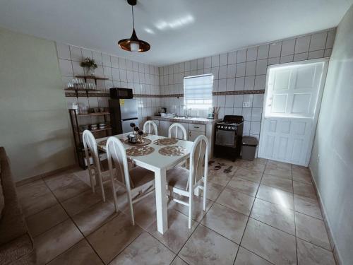 a kitchen with a table and chairs in a room at Passion Care in Willemstad