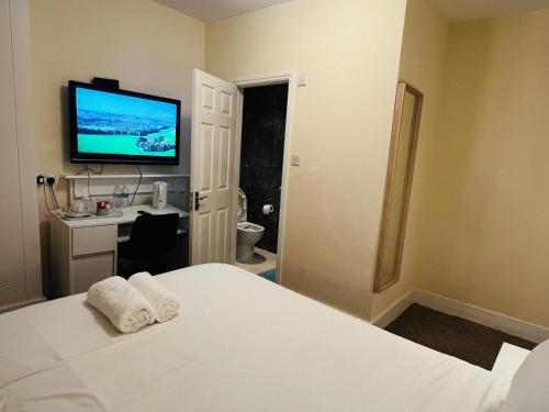 a bedroom with a bed with a television on the wall at Vauxhall Stay in London
