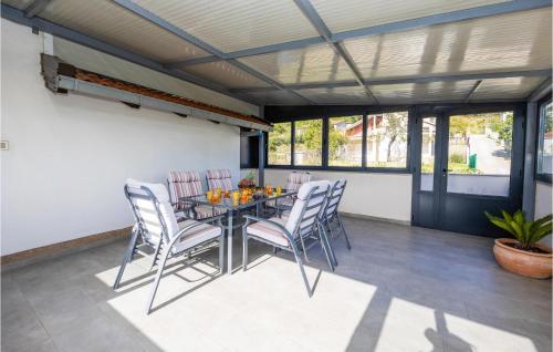 a dining room with a table and chairs at Beautiful Home In Tugare in Tugare
