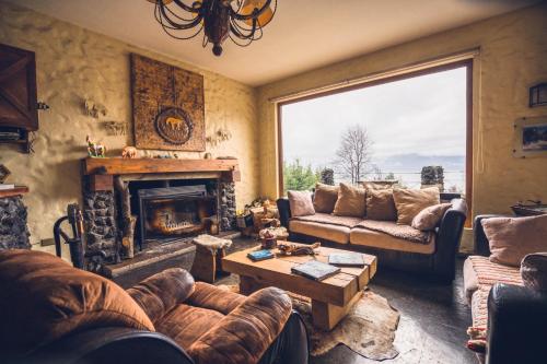 a living room with a couch and a fireplace at Hotel CasaEstablo by DOT Boutique in Pucón