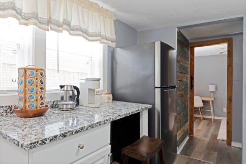 a kitchen with a counter top and a refrigerator at Summerset Cottage Atlanta in Atlanta