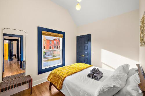 a bedroom with a bed with a teddy bear on it at The Little Big House - Home in Downtown Ann Arbor in Ann Arbor