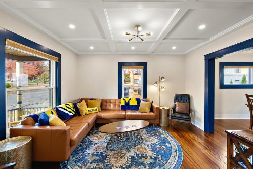 a living room with a couch and a table at The Little Big House - Home in Downtown Ann Arbor in Ann Arbor