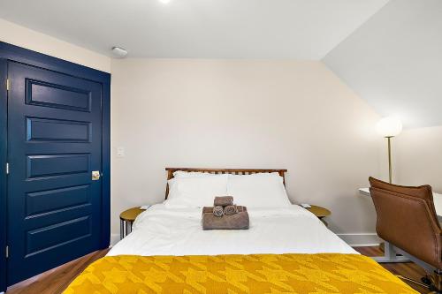 a bedroom with a bed and a blue door at The Little Big House - Home in Downtown Ann Arbor in Ann Arbor