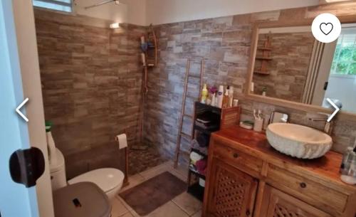 a bathroom with a toilet and a sink and a shower at VILLA LAURAYM in Baie-Mahault