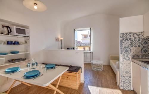 a small kitchen with a white table and a room at Amazing Apartment In Varazze With Wifi in Varazze