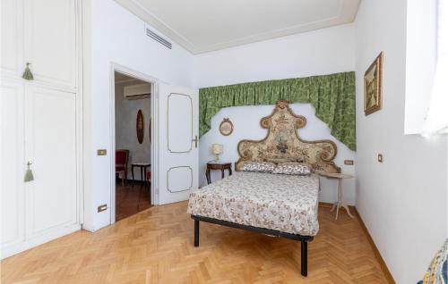 a bedroom with a bed and a green wall at Gorgeous Home In Viareggio With Kitchen in Viareggio