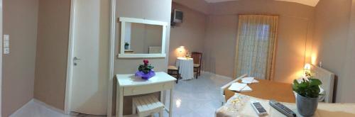 a living room with a table and a mirror at Family Studios in Marathias