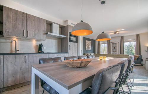 a kitchen and dining room with a wooden table and chairs at 4 Bedroom Gorgeous Home In Den Ham in Den Ham
