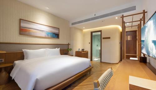 Ένα ή περισσότερα κρεβάτια σε δωμάτιο στο Iconic Long Hai Hotel